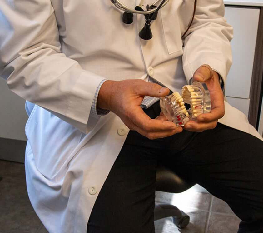 Dr. Dawkins holding a model of teeth