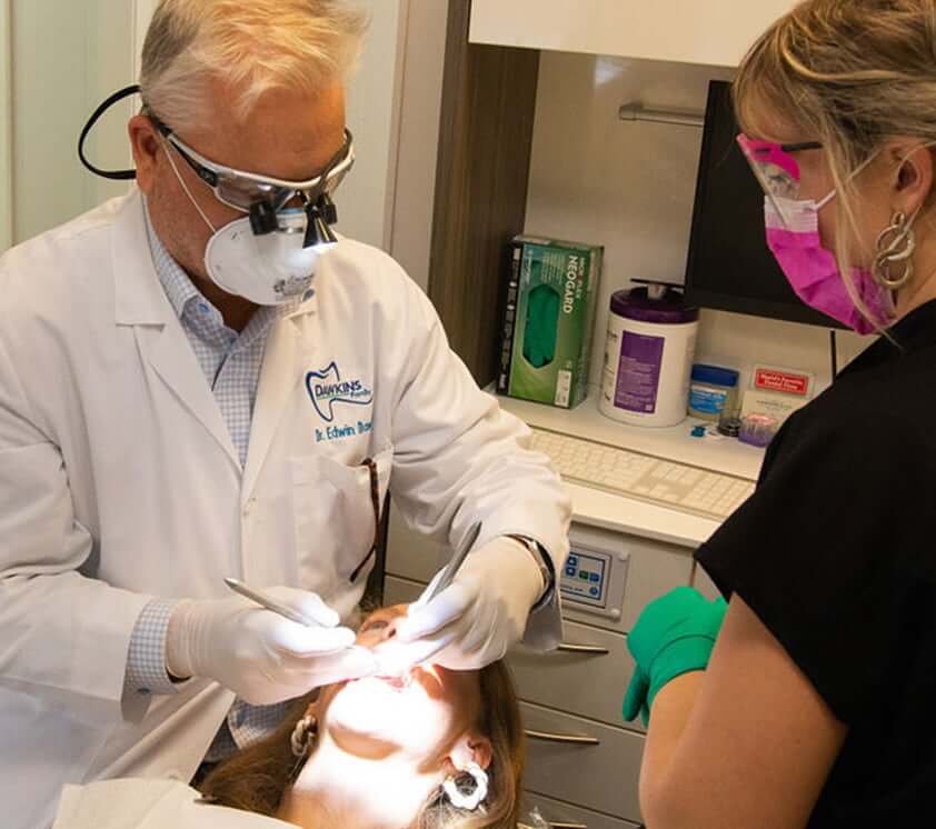 Dr. Dawkins and a staff member working with a patient