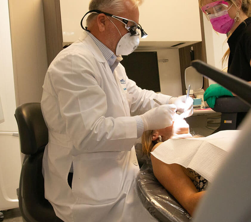 Dr. Dawkins and a staff member working with a patient