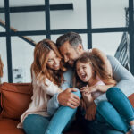 Photograph of a happy, young family accompanying a dental blog post about family friendly dentists.