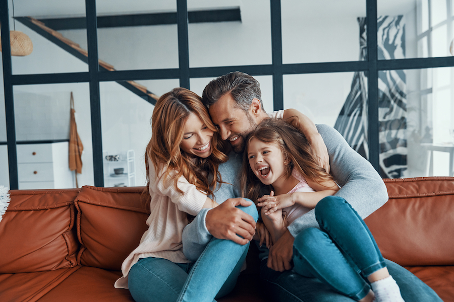 Photograph of a happy, young family accompanying a dental blog post about family friendly dentists.